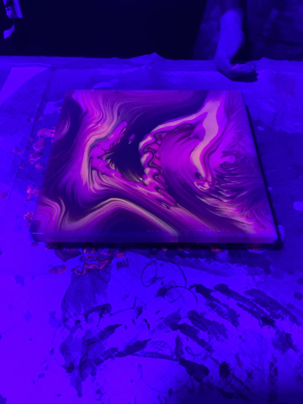 Glow-in-the-dark fluid art painting under blacklight at Makers Art Studio Danville